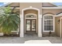 Elegant entryway with double doors, decorative columns, and brick pavers at 1372 Madison Ivy Cir, Apopka, FL 32712