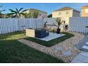 Landscaped backyard oasis featuring a cozy seating area with a porch swing and well-maintained lawn at 14417 Jasmine Glen Dr, Orlando, FL 32824