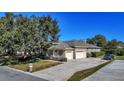 Spacious home with a three-car garage, a long driveway, and well-manicured lawn and landscaping at 867 Hanover Way, Lakeland, FL 33813