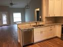 Modern kitchen featuring white cabinets, granite countertops, and stainless steel appliances at 261 E 5Th St, Chuluota, FL 32766