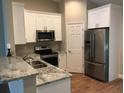 Well-equipped kitchen with granite counters, stainless steel appliances, and ample storage space at 261 E 5Th St, Chuluota, FL 32766