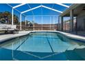 Sparkling pool featuring a safety fence, covered lanai, and comfortable seating at 1112 View Pointe Cir, Lake Wales, FL 33853
