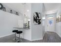 Inviting entryway with a view to the kitchen and a decorative light fixture at 3548 Galloway Oaks Ct, Lakeland, FL 33810