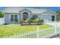 Well-maintained home with a white picket fence, lush lawn, and inviting curb appeal at 3548 Galloway Oaks Ct, Lakeland, FL 33810