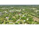 Expansive aerial view showing the home nestled within a lush, wooded community at 4609 Creek Meadow Trl, Lakeland, FL 33810