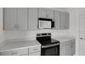 This kitchen has sleek countertops, grey cabinets, and modern stainless steel appliances at 140 Jones Fish Camp Rd, Edgewater, FL 32141