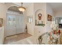 Bright foyer boasts double doors, tile flooring, and an arched transom window at 10837 Versailles Blvd, Clermont, FL 34711