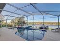 Screened-in pool offers a beautiful view of the lake at 10837 Versailles Blvd, Clermont, FL 34711