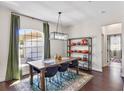 Bright dining room with modern lighting, large windows, and view of the front yard at 3688 Hurlbut Cir, Lake Wales, FL 33898