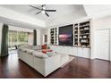 Cozy living room featuring custom built-ins, hardwood floors, and lots of natural light at 3688 Hurlbut Cir, Lake Wales, FL 33898