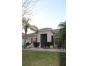 Inviting entryway with a screened porch and well-maintained landscaping and a tile roof at 4002 Bougainvillea Pl, Kissimmee, FL 34746