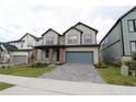 A charming two-story home with a manicured lawn and a two-car garage at 16906 Cedar Valley Cir, Clermont, FL 34711