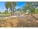 Single story home featuring a fenced yard, mature trees, and a shed at 2415 Sutton Rd, Lakeland, FL 33810