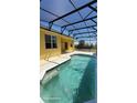 Beautiful backyard pool with screened enclosure and a spacious patio area at 447 Wildflower Rd, Davenport, FL 33837