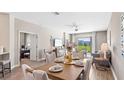 Elegant dining room with a decorative centerpiece on a wooden table and an open view to the living area at 5038 Barnet Dr, Davenport, FL 33837