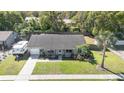 Aerial view of a home with a well manicured lawn, mature trees, and an RV parked in the driveway at 820 Rio Ala Mano Dr, Altamonte Springs, FL 32714