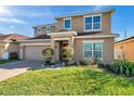 Charming two-story home with a brick driveway, manicured lawn, and well-maintained landscaping at 4706 Rockvale Dr, Kissimmee, FL 34758