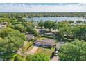 Aerial view of a single-story home with a view of a lake and lush greenery at 1005 Catalpa Ln, Orlando, FL 32806