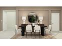 Elegant dining room features a modern table with seating for six under a decorative round mirror at 2059 Rider Rain Ln, Apopka, FL 32703