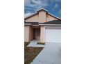 Single-Gathering home featuring an attached garage and front yard with minimalist landscaping at 602 Hillcrest Dr, Davenport, FL 33897