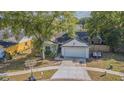 Inviting single-story home featuring mature trees and landscaping in a peaceful neighborhood at 6125 Morningdale Ave, Lakeland, FL 33813