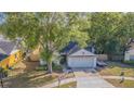 Inviting single-story home featuring mature trees and landscaping in a peaceful neighborhood at 6125 Morningdale Ave, Lakeland, FL 33813