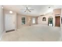 Bright living room featuring neutral carpet, ample windows, and an open layout at 2076 Whispering Trails Blvd, Winter Haven, FL 33884