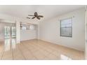 Open living room with tile flooring, a ceiling fan, and natural light from the window at 265 Elderberry Dr, Davenport, FL 33897