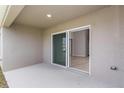 Covered patio featuring a sliding glass door entry that offers seamless indoor-outdoor living at 1026 Foreshore Ln, Haines City, FL 33844