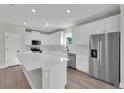 Modern kitchen boasts stainless steel appliances, white cabinets, and quartz countertops at 17745 Sw 25Th Ave Rd, Ocala, FL 34473