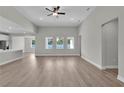 Bright, open-concept living room with hardwood flooring and modern ceiling fan at 17745 Sw 25Th Ave Rd, Ocala, FL 34473