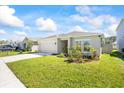 Well-kept home with a two-car garage, manicured lawn and tasteful landscaping at 2047 Rosewood Cir, Lakeland, FL 33810