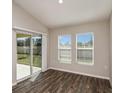 Cozy living room with hardwood floors and sliding glass door leading to the patio at 1542 Sage Ave, Haines City, FL 33844