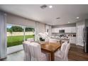 Bright dining area features a wooden table set with a backyard view at 1562 Sage Ave, Haines City, FL 33844