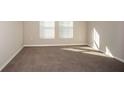 Neutral bedroom featuring plush carpeting and natural light from the two window at 1570 Sage Ave, Haines City, FL 33844