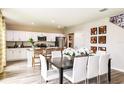 Eat-in kitchen with white cabinets, stainless steel appliances, island, and dining area at 1574 Sage Ave, Haines City, FL 33844