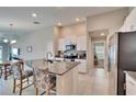 Bright kitchen featuring a center island, stainless steel appliances, and white cabinetry at 1792 Yellow Trl, Lakeland, FL 33801