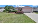 Well-maintained lawn and lush landscaping complement this charming single-Gathering home at 15213 Sw 14Th Avenue Rd, Ocala, FL 34473