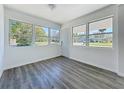 Sun-filled living room featuring updated laminate floors and freshly painted walls and trim at 218 W Magnolia St, Clermont, FL 34711