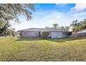 Well-maintained home featuring a spacious yard with a neatly manicured lawn and mature trees at 3247 S Polk Ave, Lakeland, FL 33803