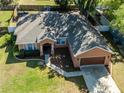 Aerial view of the property showcasing the home's layout, landscaping, and neighborhood at 5416 Oxford Manor Cir, Lakeland, FL 33810