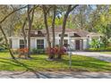 Attractive one-story home with a lush front yard and mature trees in a serene setting at 638 Coral Way, Winter Springs, FL 32708