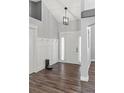 Bright foyer with wood-look flooring, paneled walls, and modern lighting at 638 Coral Way, Winter Springs, FL 32708