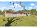 Beautiful brick home featuring a lush green lawn and mature trees at 4305 Hamilton Rd, Lakeland, FL 33811