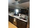 Open kitchen featuring granite counters, a stainless steel dishwasher, and rich cabinetry at 4305 Hamilton Rd, Lakeland, FL 33811