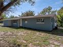 Well-maintained blue brick home with manicured lawn on a sunny day at 501 15Th Ne Ct, Winter Haven, FL 33881