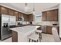Modern kitchen with stainless steel appliances, a large island with seating, and stylish cabinetry at 1431 Hamilton Way, Lake Alfred, FL 33850