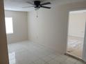 Bright living room featuring tiled floors, a ceiling fan and open doorway to a bedroom at 308 Summer Field Dr, Winter Haven, FL 33880