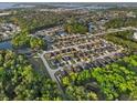 Beautiful aerial view of a residential community with lush landscaping and small ponds throughout at 1413 Wallace Manor Pass, Winter Haven, FL 33880