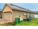 Exterior shot of the home with solar panels, tidy landscaping and a fenced yard for outdoor activities at 3035 Buckeye Pointe Dr, Winter Haven, FL 33881